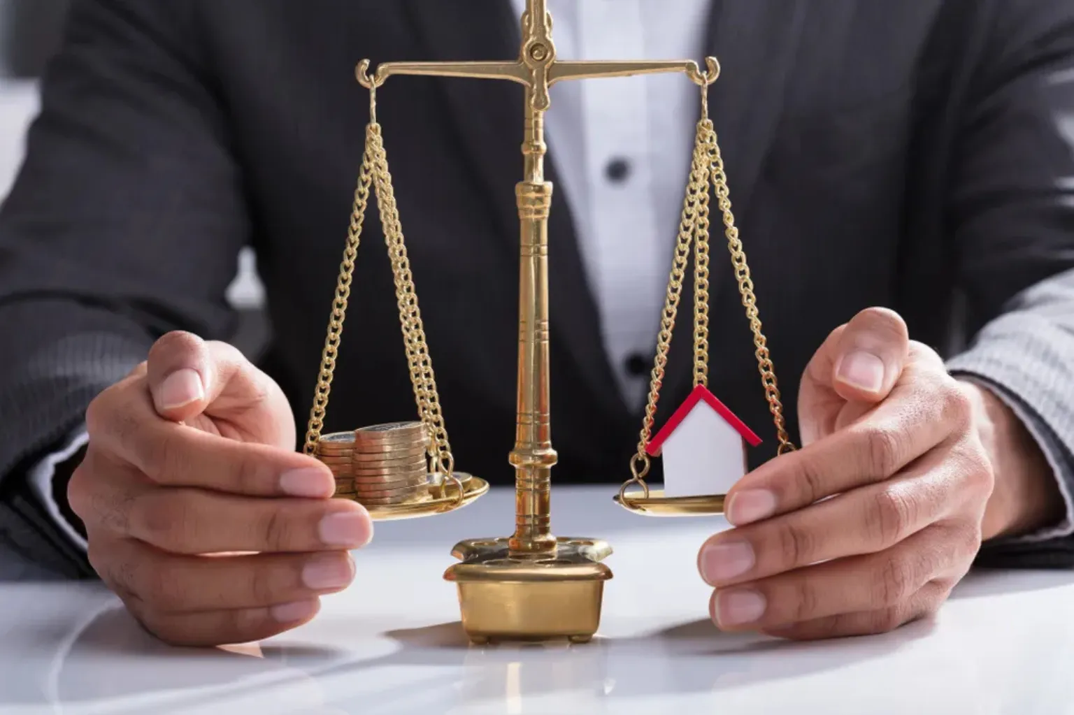 A lawyer with a justice scale weighing money and a house.